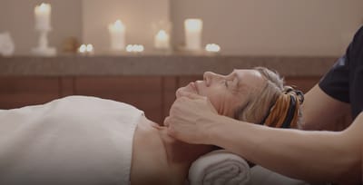 Resident receiving a facial treatment in a spa setting.