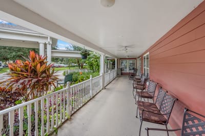 Covered porch area with seating and plants