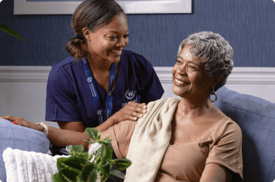 Caregiver interacting with senior resident