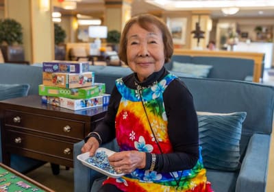 Senior woman working on a puzzle in a common area