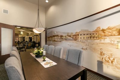 Common area with a dining table and mural