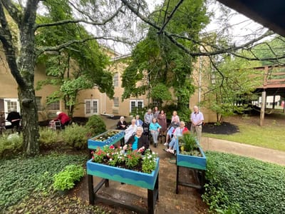 Residents enjoying time together in a garden area