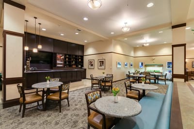 Dining area with tables and seating in a common space.