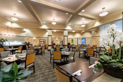 Spacious dining room with tables and chairs.