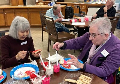 Residents decorating cookies during an activity.