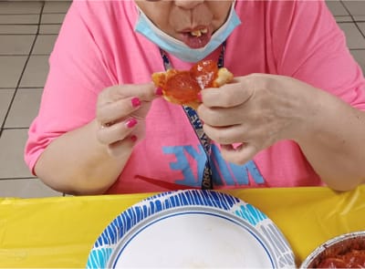 Resident enjoying food in communal dining area.