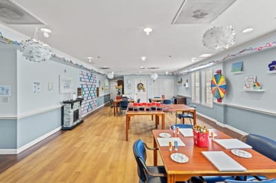 Art and activity room with tables and decor