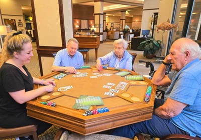 Residents playing cards in a common area.