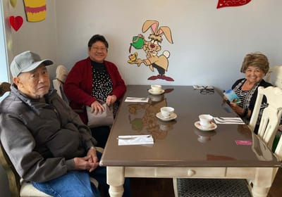 Residents enjoying tea in a common area.