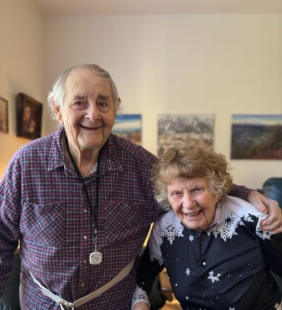 Two smiling residents in a cozy living area