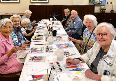 Residents enjoying a painting activity together
