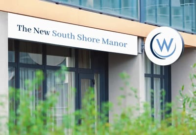 Exterior view of The New South Shore Manor building with logo.
