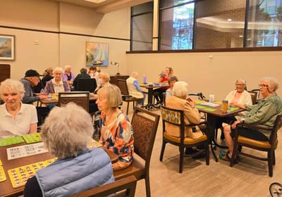 Residents enjoying a game of bingo in a common area.