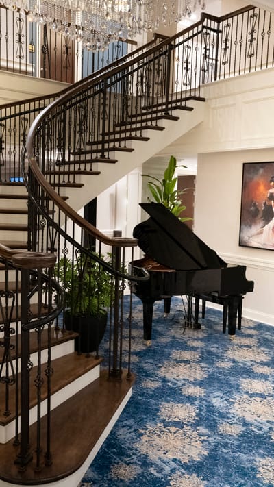 Elegant stairway and grand piano in the lobby.