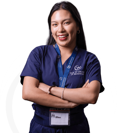 Staff member smiling with arms crossed