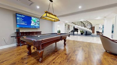 Indoor game room with a pool table and seating.