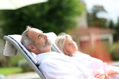 Two residents relaxing outdoors in robes