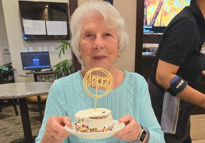 Resident celebrating birthday with cake.