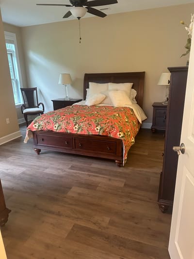 Cozy bedroom with floral bedding in a senior living facility