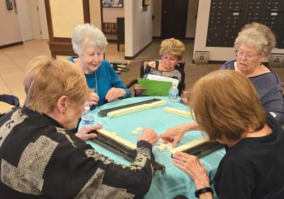 Residents engaged in a game of dominoes