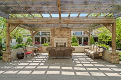 Outdoor seating area with pergola and greenery