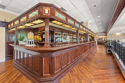 Elegant dining area with wooden bar and decorations.