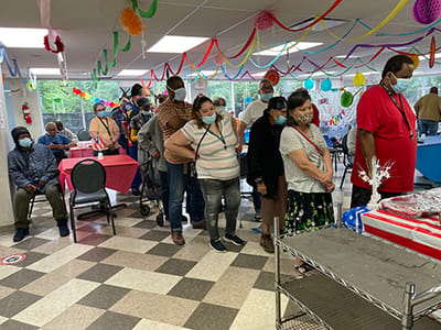 Residents participating in a festive indoor activity.