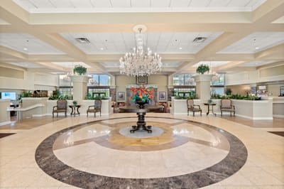 Elegant lobby area with chandelier and floral arrangement
