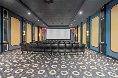 Interior theater seating area with black chairs.