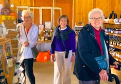 Three women enjoying a social activity indoors.