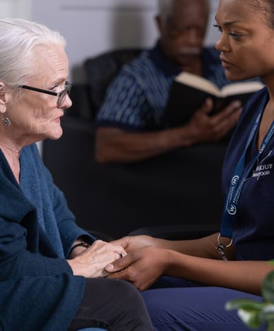 Caregiver and resident in a compassionate interaction