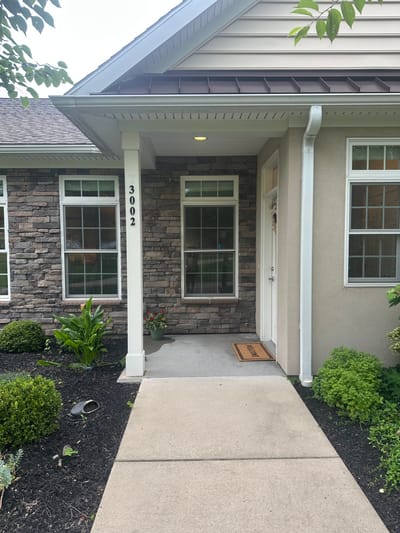 Front entrance of a senior living facility with landscaped area