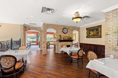 Dining area with tables and a view of the outdoors.