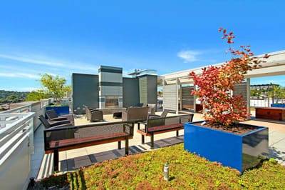 Outdoor patio area with seating and landscaping.