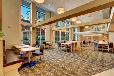 Bright dining area with large windows and seating