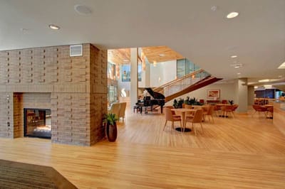 Bright common area with piano and seating