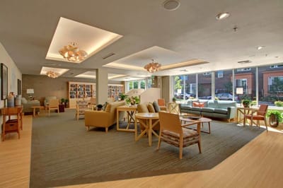 Cozy common area with seating and bookshelves.