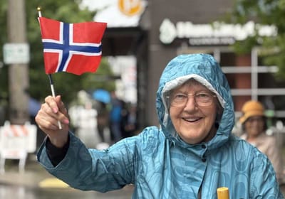 Elderly woman celebrating with a Norwegian flag