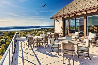 Outdoor patio area with chairs and a view.