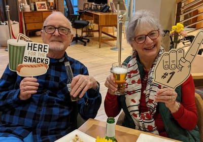 Two residents enjoying snacks and drinks together.