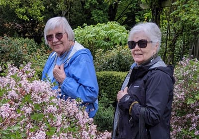 Two senior women enjoying a garden
