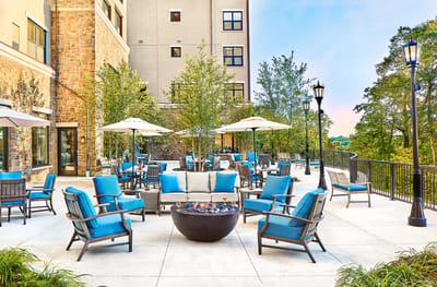 Outdoor lounge area with seating and fire pit.