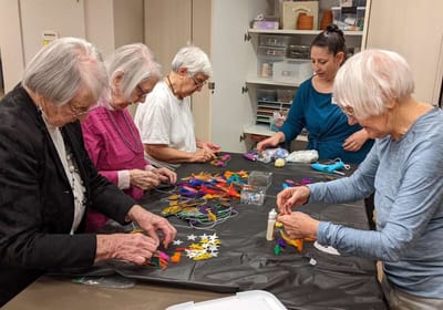 Residents creating crafts together in a common area