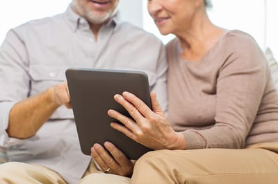 Two seniors engaged with a tablet together
