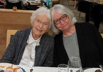 Two women smiling at a dining table