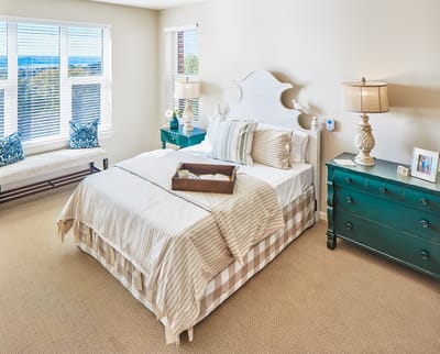 Cozy resident room with a bed and bright decor.