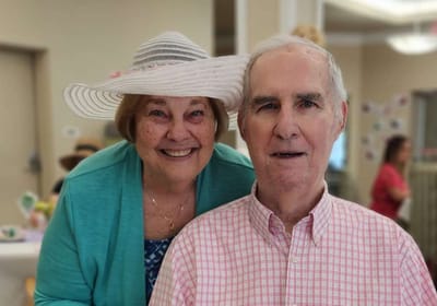 Two residents celebrating together with smiles.
