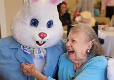 Resident joyfully interacting with a costumed character.