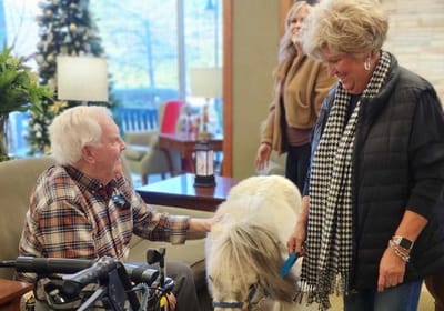 Residents interacting with a dog indoors