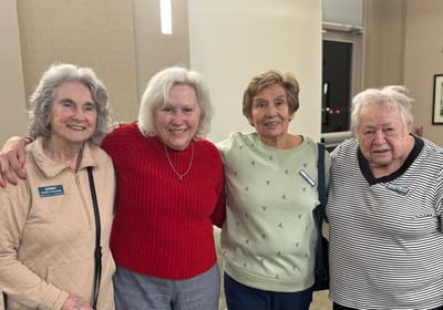Four residents posing together in a common area.